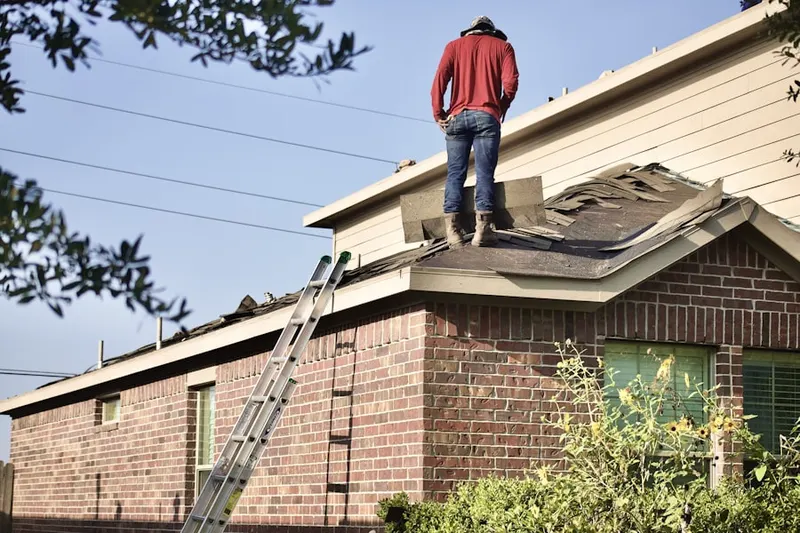 Professional roofer working on a residential roof in University City